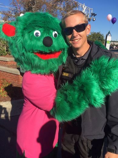 Child Abuse Reduction Effort (C.A.R.E.) mascot with officer.